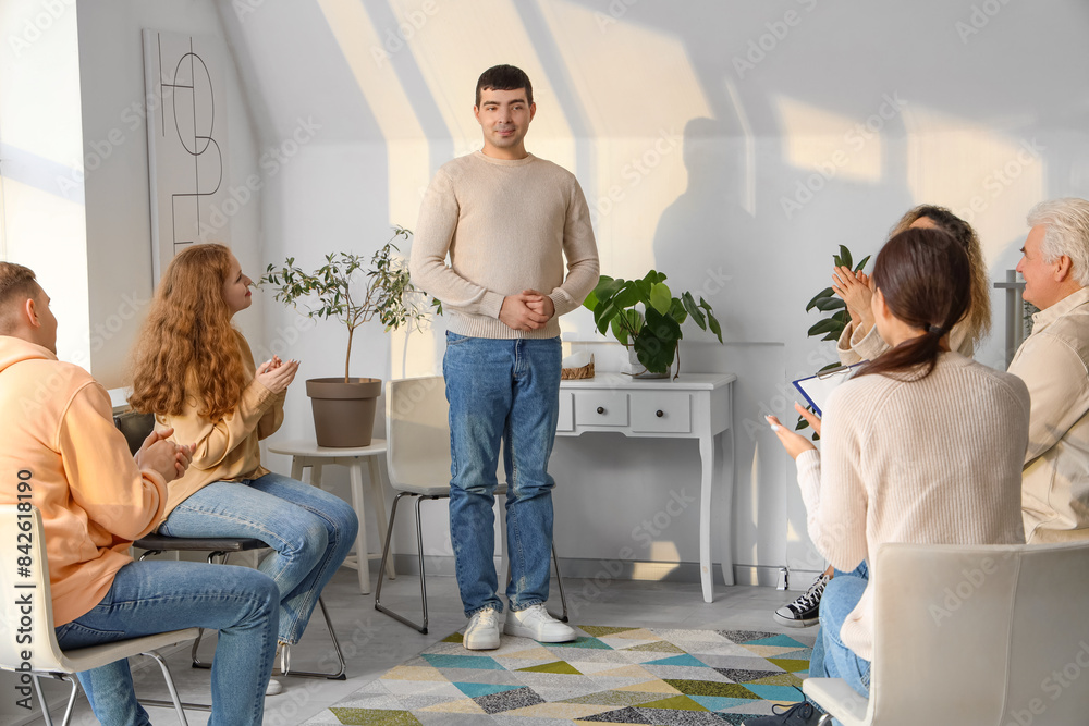 Canvas Prints Young man and people clapping their hands at group therapy session