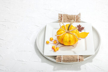 Autumn table setting. Thanksgiving cutlery, traditional fall decor. Cozy mood, minimalist design