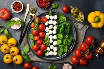 Traditional Italian Caprese salad with tomatoes, mozzarella cheese and basil. Top view.