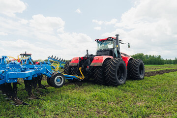 harvest field with red tractor mods dry grass. field after harvest. Harvesting in the fields. Stock up on hay for winter. plowing a field with a red tractor. tillage