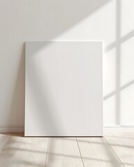 front view of one white blank canvas leaning against the wall 