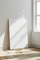 front view of one white blank canvas leaning against the wall 