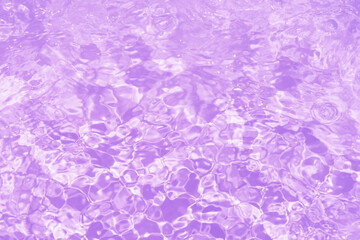 Obraz premium Pink water bubbles on the surface ripples. Defocus blurred transparent pink colored clear calm water surface texture with splash and bubbles. Water waves with shining pattern texture background.