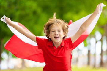 Obraz premium Child running with Poland flag. Little Polish fan