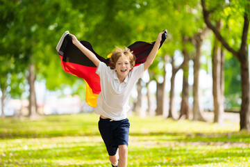 Child running with Germany flag.