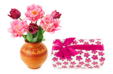 A gift in festive packaging and tulips in a vase isolated on white. Collage. Free space for text.