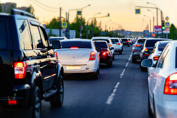 Background, blur, out of focus, bokeh. Traffic jams during rush hours after work. Red brake lights of stopped cars on the background of the city neighborhood.