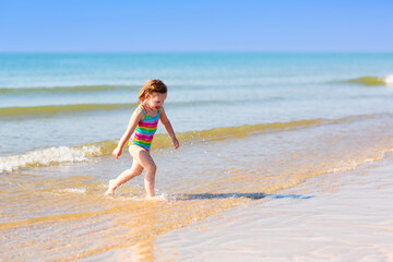 Kids playing on beach. Children play at sea.
