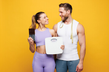 Young strong fitness trainer instructor sporty two man woman wear blue clothes spend time in home...