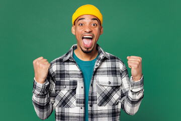 Young happy man of African American ethnicity he wear shirt blue t-shirt yellow hat doing winner...