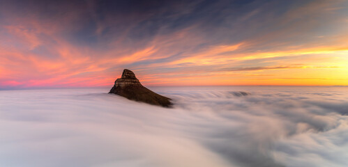 View of foggy sunset over Lion's Head mountain, Table Mountain, Cape Town, South Africa.