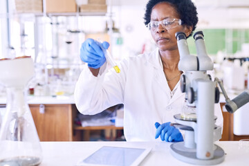 Black woman, test tube sample and in lab for science, innovation and medical healthcare development. Scientist, microscope and chemistry experiment for discovery, breakthrough and vaccine research
