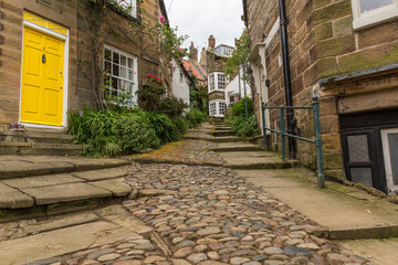 Cobblestone path through a narrow street in a old fishing village of Robin Hoods Bay, North Yorkshire