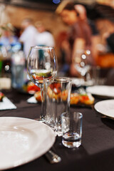 Empty glasses and a plate on a served banquet table. Catering.