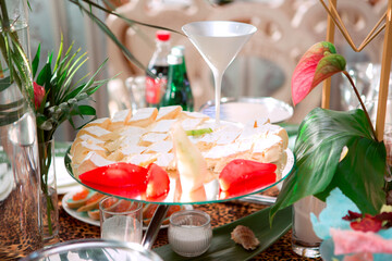 A table with a variety of food and drinks, including a martini glass