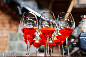 glasses of red cocktails on the bar. refreshing light alcoholic drinks for the party. aperol