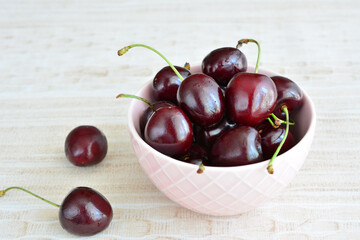 a bowl of cherries isolated on the table