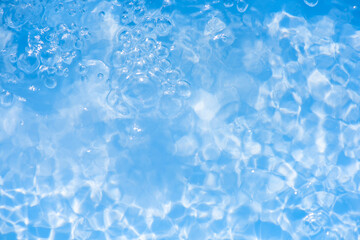 Blue water with ripples on the surface. Defocus blurred transparent blue colored clear calm water...