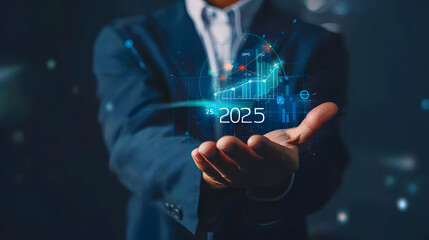 Businessman holding a virtual hologram icon of a growth graph and arrow up with the text 2025 