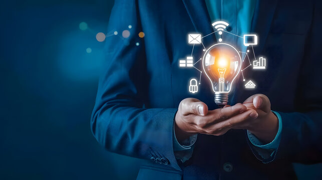 Businessman holding light bulb with digital marketing icons on hand. business innovation and creative idea concept. photo of man in blue suit  - Powered by Adobe