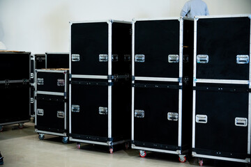 Flightcase of concert music and video equipment stacked behind the stage