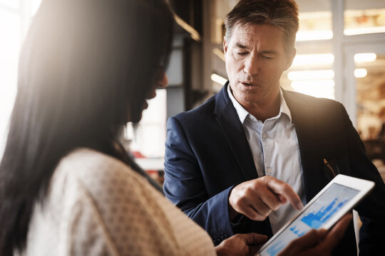 Business, people and office with statistics on tablet for teamwork, collaboration and discussion on company growth. Employee, accountant and conversation with feedback, report and financial statement