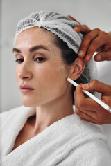 Contour plastic facial skin. A woman receives skin healing.