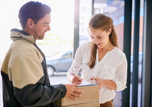 Signing, delivery man and woman with package for courier drop off with receipt for company with lens flare. Shipping, business and parcel for customer in workplace with writing for order confirmation