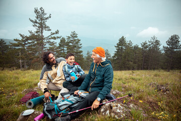 Happy family laughing together on a mountain hiking break