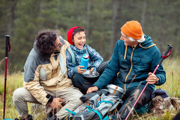 Happy family laughing together on a mountain hiking break