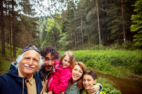 Three generation family selfie during a nature walk in the forest