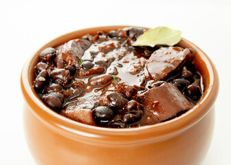 Brazilian Feijoada Food black bean stew with bacon, pork sausage and dried meat white background