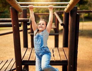 Girl, hanging and monkey bars play outdoors playground, climbing or games with exercise of motor...