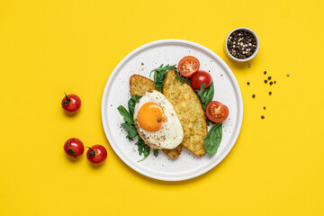 Egg, hashbrown and salad in plate on yellow background with copy space