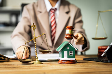 A young businesswoman is working at her desk, reviewing contracts and preparing for litigation,...