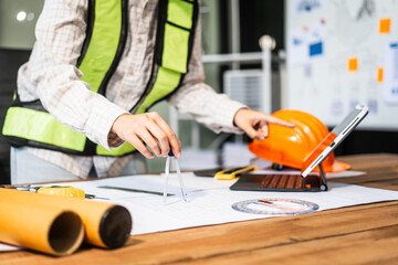 Female architect engineer is drafting blueprints using CAD software, focusing on sustainable infrastructure, renewable energy solutions, and adhering to building codes