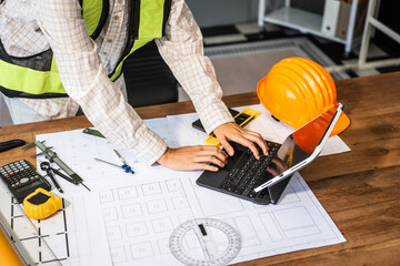 Female architect engineer is drafting blueprints using CAD software, focusing on sustainable...