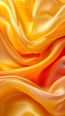 Obraz premium Yellow and orange silk fabric with smooth folds, close-up. Fashion and textile concept
