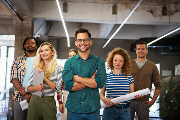 Portrait of successful creative business team looking at camera, smiling. Startup success concept.