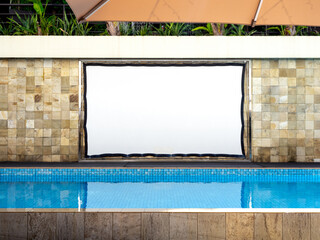 Blank white large outdoor waterproof projector screen hanging on tiles wall background near the...