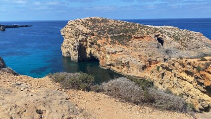 Luxury vacation. Visiting Comino caves in a boat, sea scooters and kayak . Malta, Mediterranean sea. High quality photo