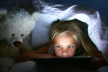 Tablet, bedroom and kid in home at night for streaming movie, video or cartoon to relax. Digital...