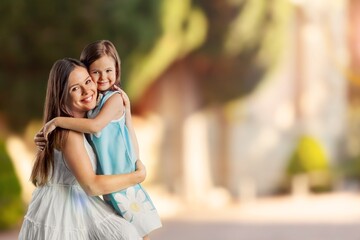 Young Mother and daughter play in forest