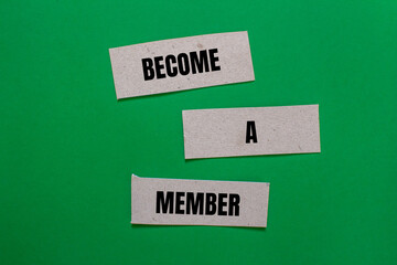 Become a member message written on paper pieces with green background. Conceptual become a member...