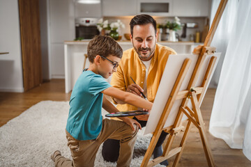 Father and son paint at home mentor artist help teach to create art