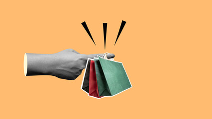 A human finger holding shopping bags