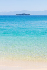Ripples of the crystal-clear sea waters near the sand of Praia do Dentista, in Ilha Grande, RJ, Brazil.