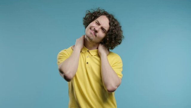 Tired man feeling pain in neck joint, massaging muscles, rubbing head. Arthritis