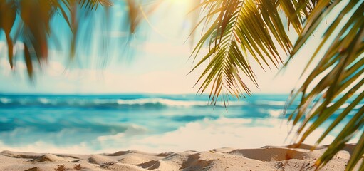 Naklejka premium Beautiful blurred background of a sandy tropical beach and palm leaves with copy space for product display, conveying a summer vacation concept