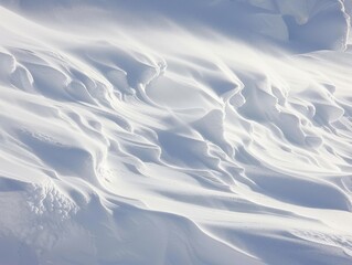 Smooth, windswept snowdrifts creating abstract patterns in a serene winter landscape. Perfect for winter backgrounds and seasonal themes.